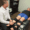 Specialist providing a manual examination of a patient’s lower legs and feet while they wear specialized compression wraps for nerve therapy.